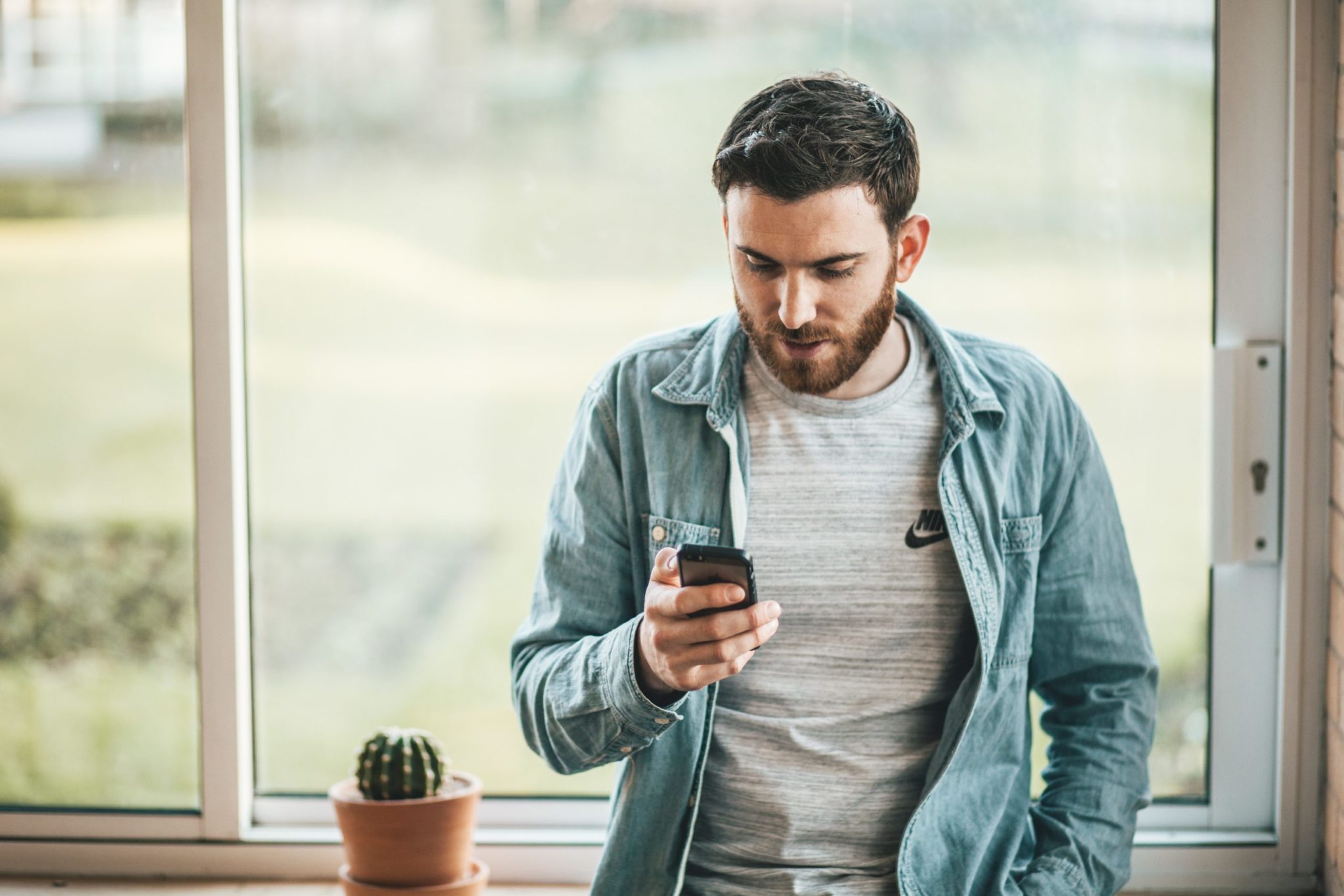 Man using phone for online shopping in New Zealand