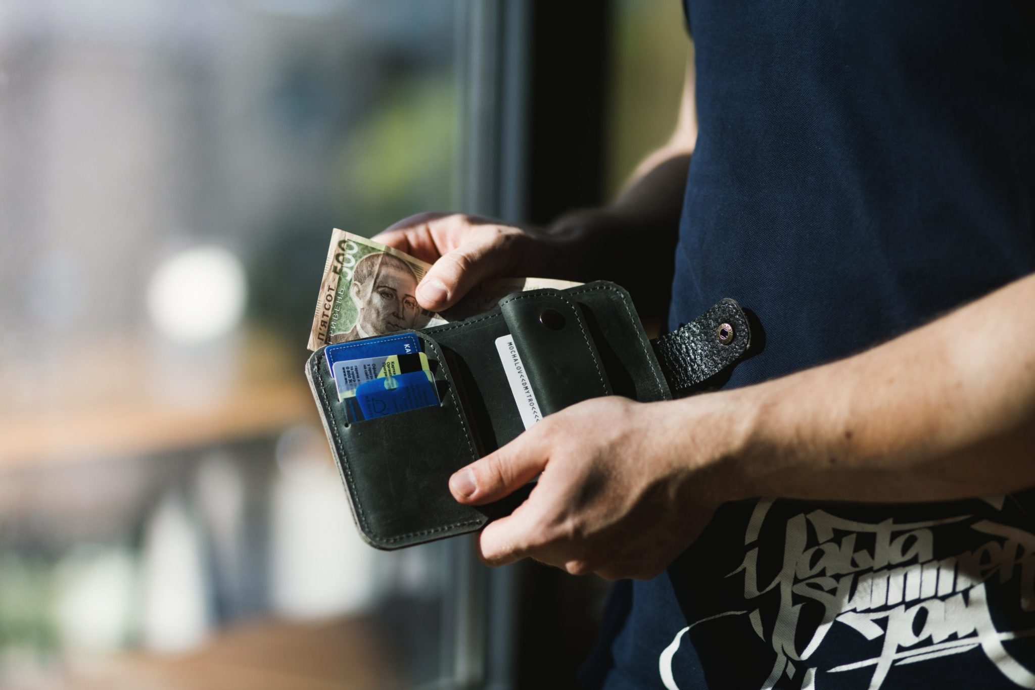 Person pulling money out of wallet