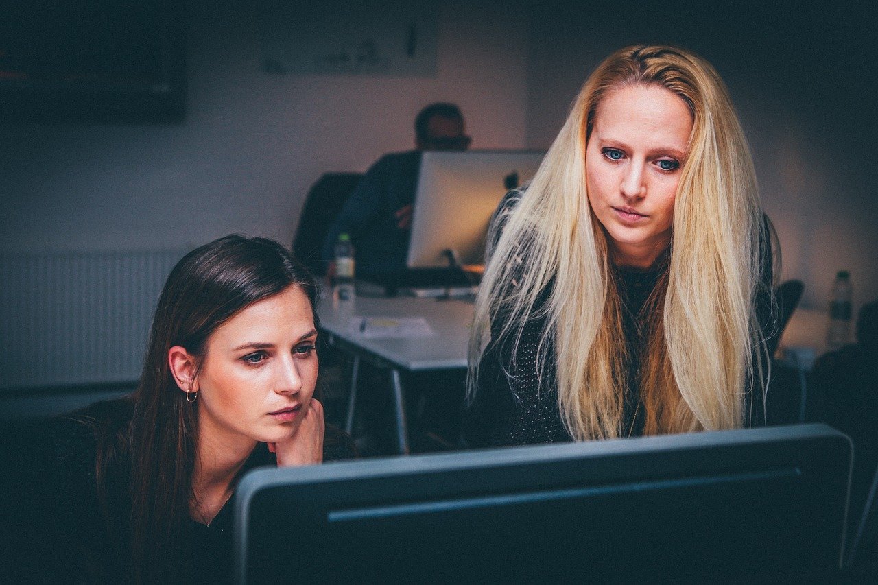 Two women researching due diligence in Brazil