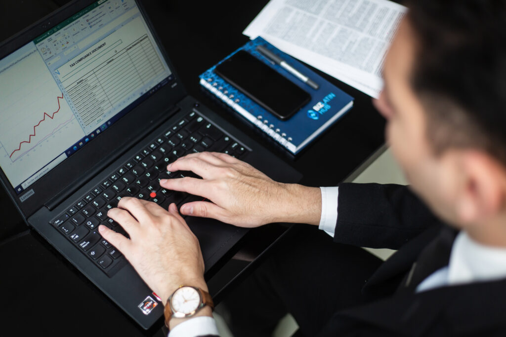 A BLH stock image of a professional using a computer, highlighting the fact that part of the process when you form a branch in the Dominican Republic can be done online