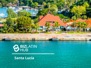 A waterfront scene with a red-roofed building surrounded by lush greenery and palm trees. The building is adjacent to a turquoise body of water, reflecting the allure of Investimento Estrangeiro Direto no Brasil. The image is branded with a 'Biz Latin Hub' logo and labeled 'Santa Lucía.'