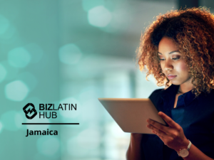 A woman with curly hair is using a tablet. The background appears blurry with teal lights. The words "BizLatin Hub Jamaica" are displayed on the left side of the image.